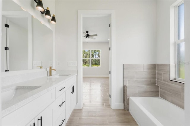 437 Mercedes Ct, Lehigh Acres, FL 33972 - full bathroom featuring double vanity, a garden tub, ceiling fan, and tile patterned floors
