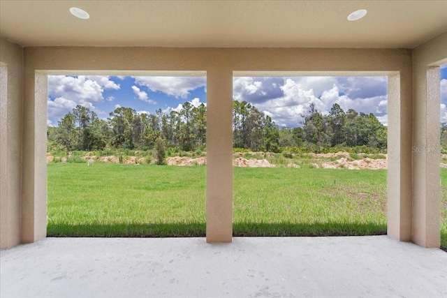 437 Mercedes Ct, Lehigh Acres, FL 33972 - view of grassy yard with a patio area and view of wooded area