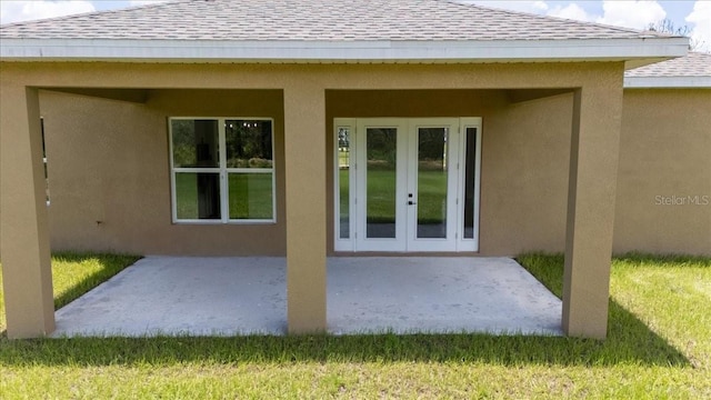 437 Mercedes Ct, Lehigh Acres, FL 33972 - back of house with french doors, roof with shingles, a patio area, and stucco siding