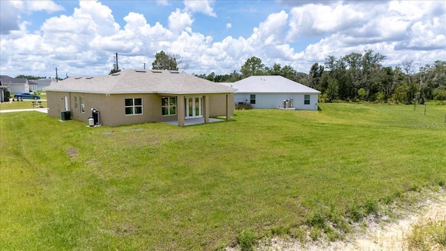 437 Mercedes Ct, Lehigh Acres, FL 33972 - rear view of house with a lawn and stucco siding