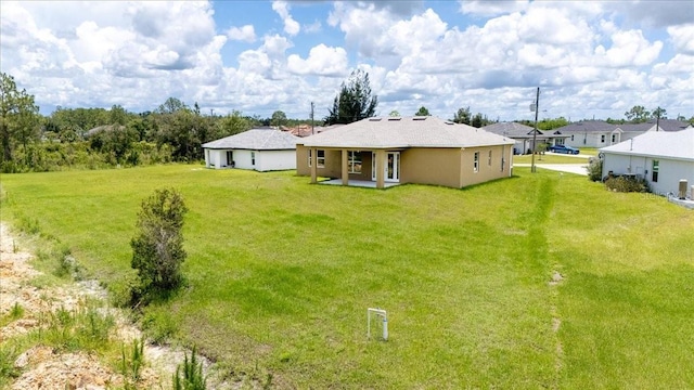 437 Mercedes Ct, Lehigh Acres, FL 33972 - rear view of property featuring a yard and a patio area