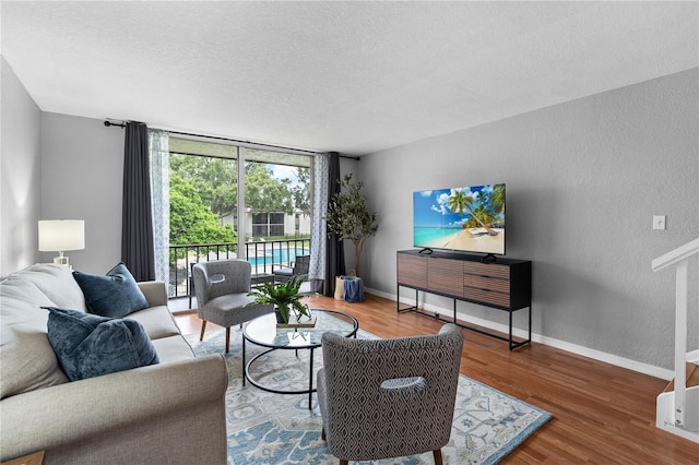 809 Russell Ln Unit 321, Brandon, FL 33510 - living area featuring wood finished floors, a textured ceiling, a textured wall, and expansive windows