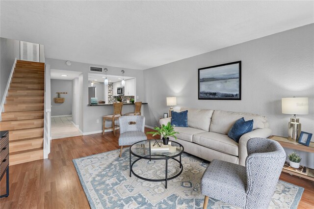 809 Russell Ln Unit 321, Brandon, FL 33510 - living room with wood finished floors and stairway