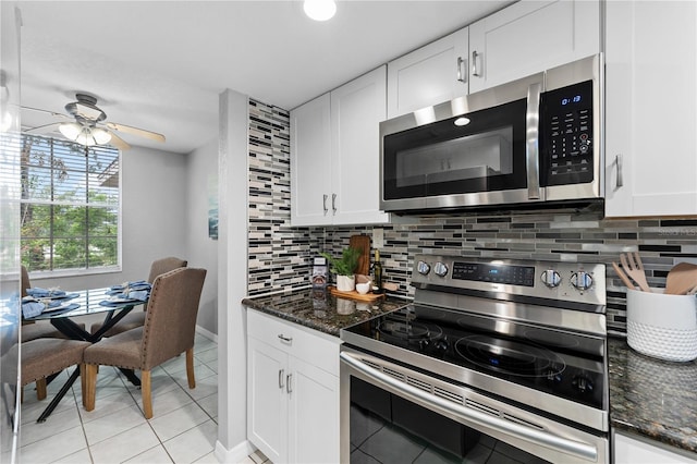 809 Russell Ln Unit 321, Brandon, FL 33510 - kitchen with stainless steel appliances, light tile patterned floors, decorative backsplash, and white cabinets