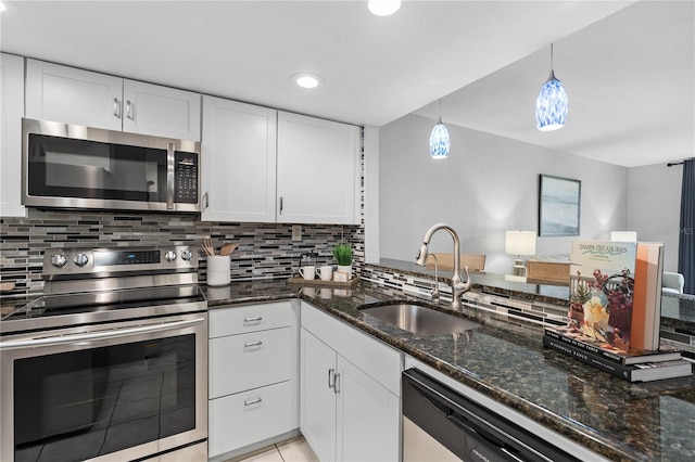809 Russell Ln Unit 321, Brandon, FL 33510 - kitchen with appliances with stainless steel finishes, white cabinets, tasteful backsplash, and recessed lighting