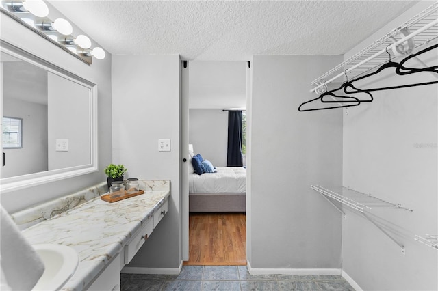 809 Russell Ln Unit 321, Brandon, FL 33510 - ensuite bathroom featuring vanity and a textured ceiling