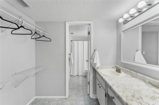 809 Russell Ln Unit 321, Brandon, FL 33510 - full bathroom with vanity, a textured ceiling, and tile patterned floors