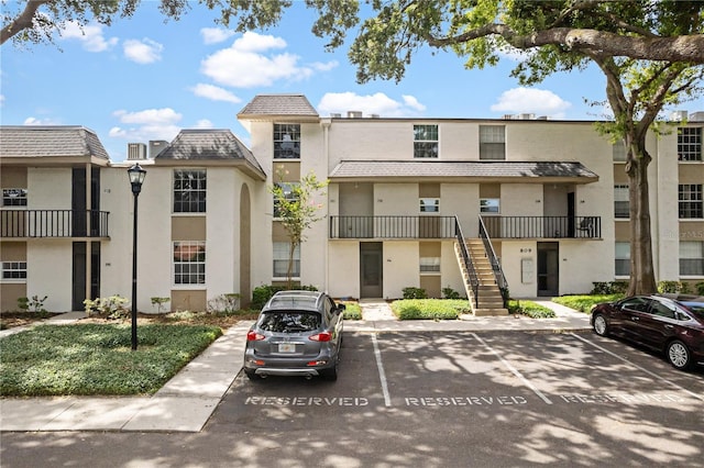 809 Russell Ln Unit 321, Brandon, FL 33510 - view of building exterior featuring uncovered parking and stairway