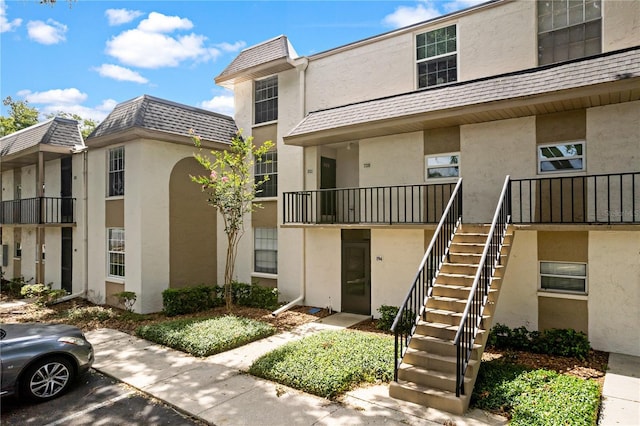 809 Russell Ln Unit 321, Brandon, FL 33510 - view of building exterior with stairs and uncovered parking
