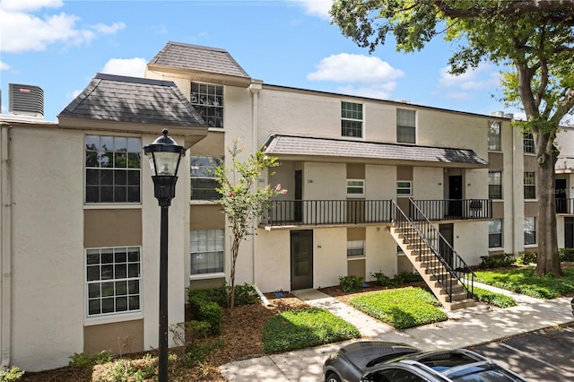 809 Russell Ln Unit 321, Brandon, FL 33510 - view of property with stairway and uncovered parking