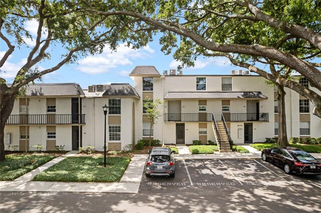 809 Russell Ln Unit 321, Brandon, FL 33510 - view of building exterior with uncovered parking and stairway