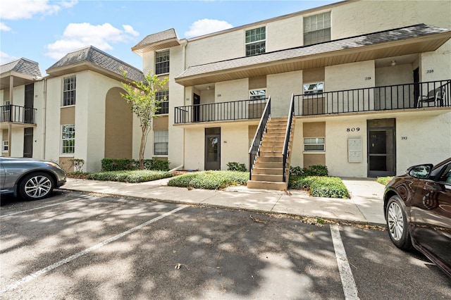 809 Russell Ln Unit 321, Brandon, FL 33510 - view of building exterior with stairway and uncovered parking