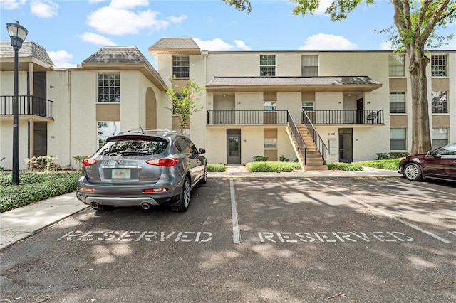 809 Russell Ln Unit 321, Brandon, FL 33510 - view of building exterior with uncovered parking and stairs