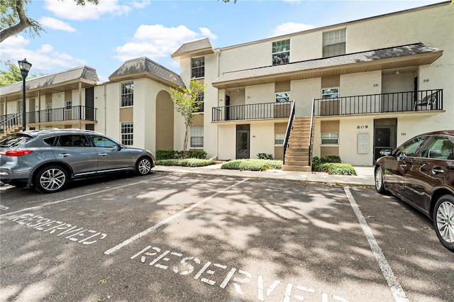 809 Russell Ln Unit 321, Brandon, FL 33510 - view of front of home with uncovered parking, stairs, and stucco siding