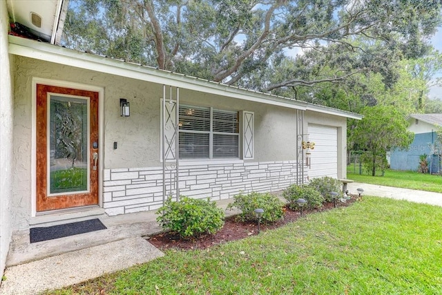 320 Pheasant Cir, Brandon, FL 33510 - property entrance with a lawn, a garage, stucco siding, driveway, and a porch