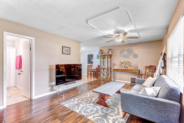 320 Pheasant Cir, Brandon, FL 33510 - living area with wood finished floors, ceiling fan, and a textured ceiling