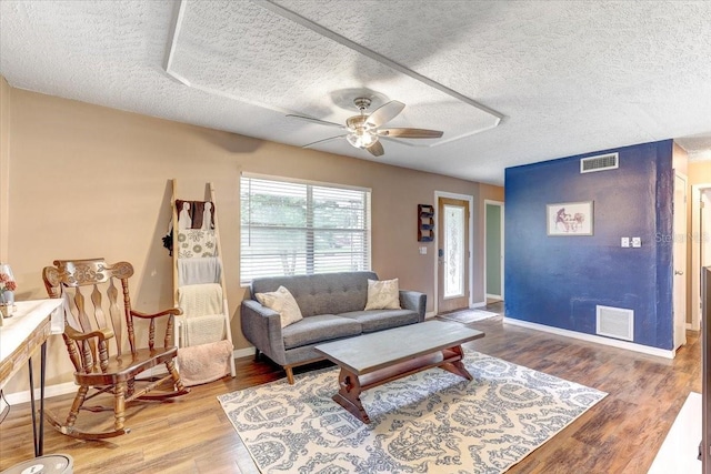 320 Pheasant Cir, Brandon, FL 33510 - living room featuring ceiling fan, wood finished floors, and a textured ceiling
