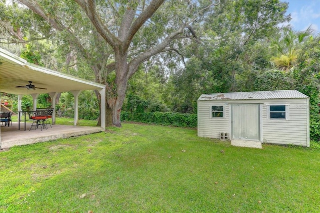320 Pheasant Cir, Brandon, FL 33510 - view of green lawn featuring a ceiling fan, a patio, and a storage unit