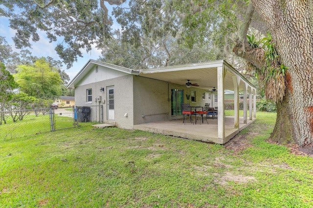 320 Pheasant Cir, Brandon, FL 33510 - rear view of property featuring a ceiling fan, a gate, stucco siding, and a patio