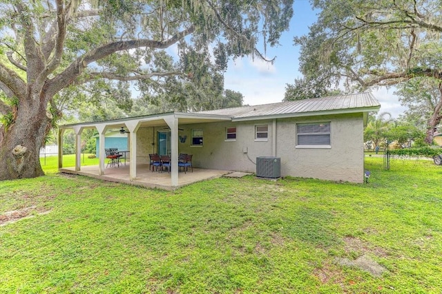320 Pheasant Cir, Brandon, FL 33510 - rear view of house with stucco siding, a yard, a patio area, a ceiling fan, and a metal roof
