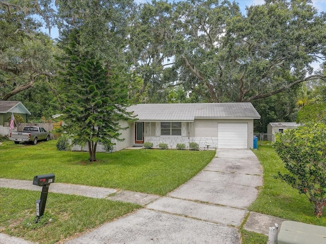 320 Pheasant Cir, Brandon, FL 33510 - view of front of property featuring stucco siding, a garage, driveway, and a front lawn