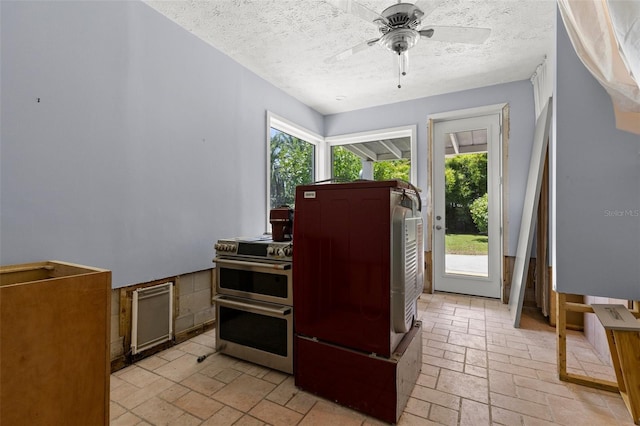 163 Barbados Ave, Tampa, FL 33606 - kitchen featuring double oven range, a textured ceiling, a ceiling fan, and fridge