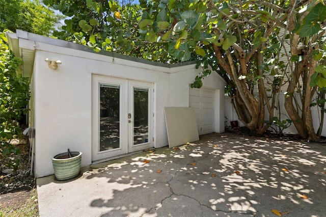 163 Barbados Ave, Tampa, FL 33606 - view of outbuilding featuring french doors, concrete driveway, and an attached garage