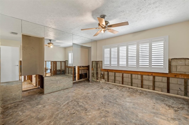 163 Barbados Ave, Tampa, FL 33606 - unfurnished living room with ceiling fan and a textured ceiling