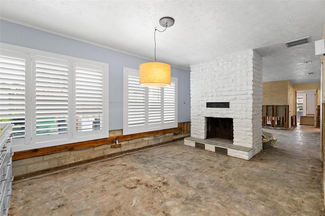 163 Barbados Ave, Tampa, FL 33606 - unfurnished living room featuring a brick fireplace, a textured ceiling, and crown molding