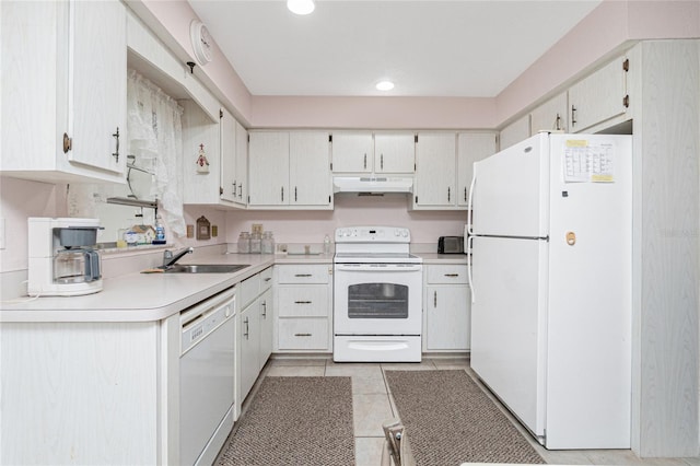 11596 SW Lemon Ave, Arcadia, FL 34269 - kitchen with white appliances, under cabinet range hood, light tile patterned floors, light countertops, and recessed lighting
