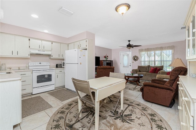 11596 SW Lemon Ave, Arcadia, FL 34269 - kitchen with white appliances, under cabinet range hood, open floor plan, light countertops, and light tile patterned floors