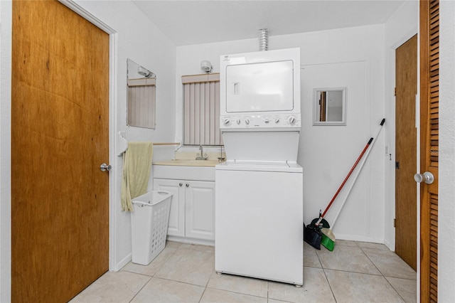 11596 SW Lemon Ave, Arcadia, FL 34269 - laundry area with stacked washer / drying machine, cabinet space, and light tile patterned flooring