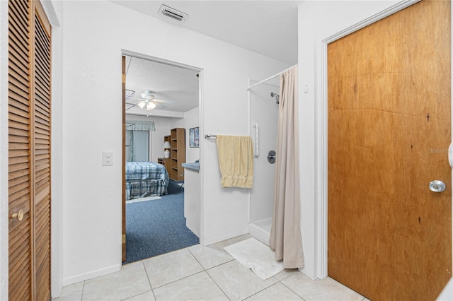 11596 SW Lemon Ave, Arcadia, FL 34269 - bathroom with ceiling fan, curtained shower, tile patterned flooring, and a closet