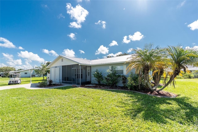 11596 SW Lemon Ave, Arcadia, FL 34269 - view of side of property featuring a sunroom, a yard, and a metal roof