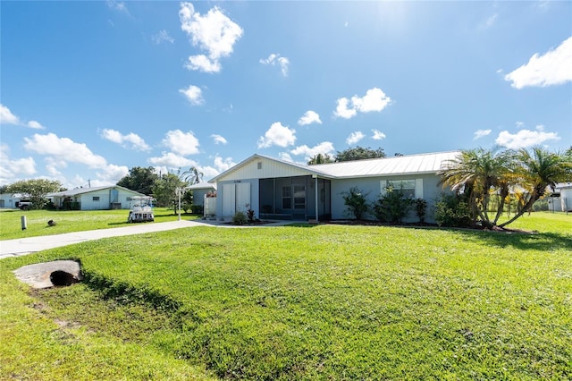11596 SW Lemon Ave, Arcadia, FL 34269 - single story home featuring driveway, a front lawn, a sunroom, and a metal roof