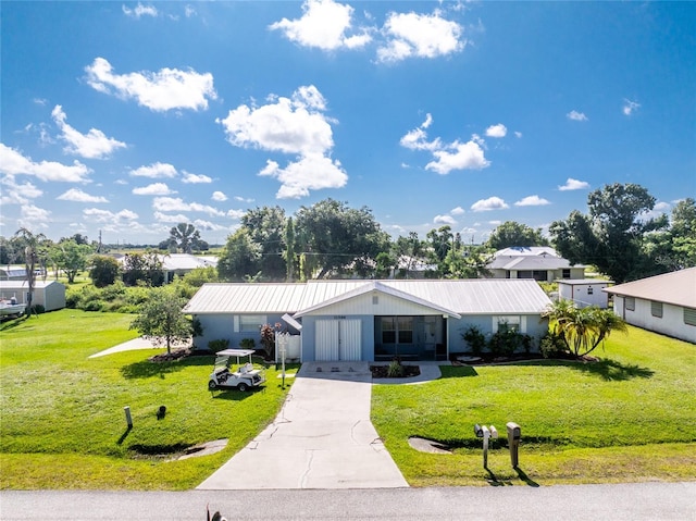 11596 SW Lemon Ave, Arcadia, FL 34269 - ranch-style house featuring a front lawn, concrete driveway, and a metal roof