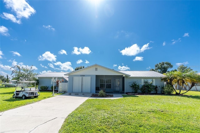 11596 SW Lemon Ave, Arcadia, FL 34269 - single story home with driveway, a front yard, and a metal roof