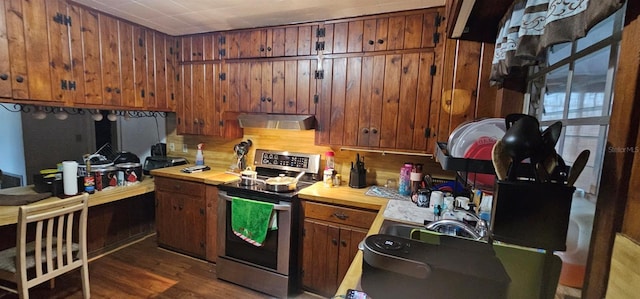 9913 Maggie St, Gibsonton, FL 33534 - kitchen featuring electric stove, range hood, wooden walls, wood finished floors, and brown cabinets