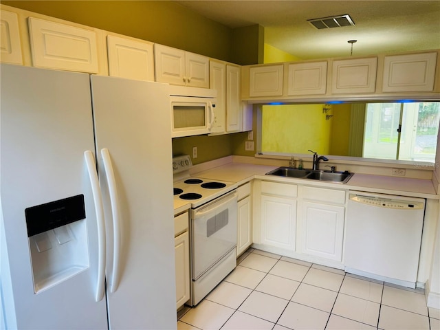 1212 Kennewick Ct, Wesley Chapel, FL 33543 - kitchen featuring white appliances, light countertops, light tile patterned flooring, and white cabinets