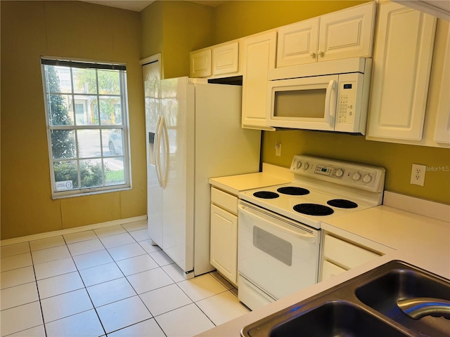 1212 Kennewick Ct, Wesley Chapel, FL 33543 - kitchen featuring white appliances, white cabinetry, light tile patterned floors, and light countertops