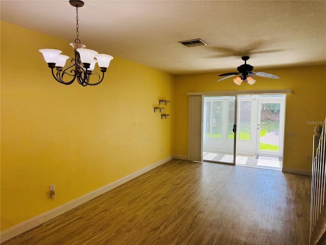 1212 Kennewick Ct, Wesley Chapel, FL 33543 - unfurnished room with wood finished floors, ceiling fan, a chandelier, and a textured ceiling
