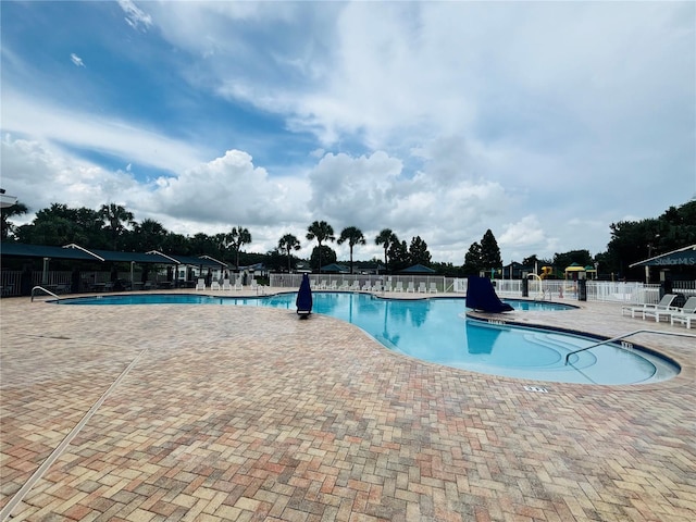 1212 Kennewick Ct, Wesley Chapel, FL 33543 - community pool featuring a patio area