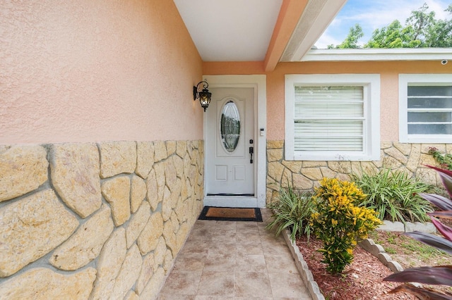 217 Bryan Rd, Brandon, FL 33511 - doorway to property featuring stone siding, stucco siding, and a surveillance system