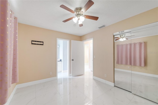 217 Bryan Rd, Brandon, FL 33511 - unfurnished bedroom featuring marble finish floors, a closet, and a ceiling fan