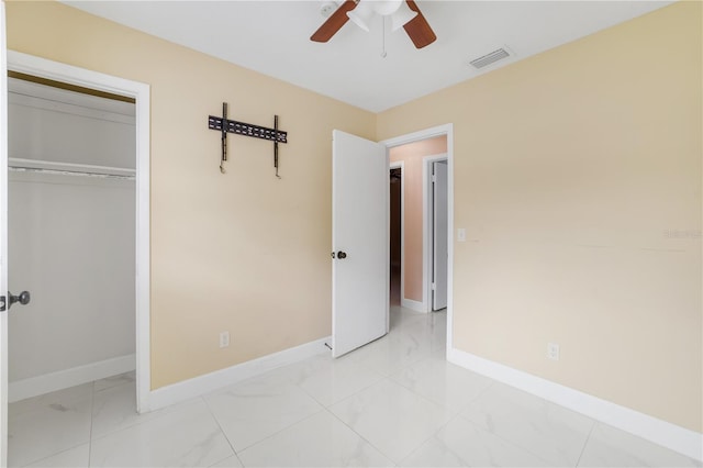 217 Bryan Rd, Brandon, FL 33511 - unfurnished bedroom with light marble finish floors, a closet, and a ceiling fan