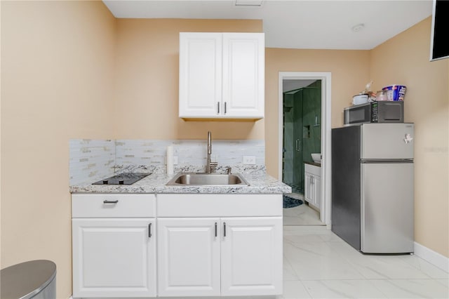 217 Bryan Rd, Brandon, FL 33511 - kitchen with appliances with stainless steel finishes, white cabinets, backsplash, and light marble finish floors