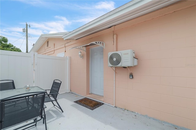 217 Bryan Rd, Brandon, FL 33511 - doorway to property featuring concrete block siding, outdoor dining area, and a patio
