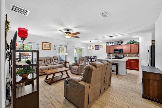 10409 Candleberry Woods Ln, Gibsonton, FL 33534 - living area with light wood-style flooring and a ceiling fan