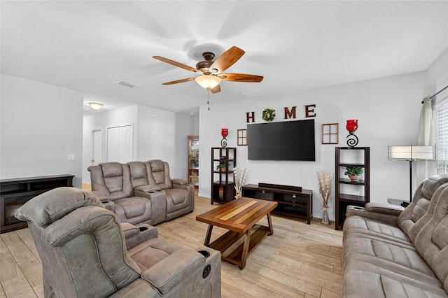 10409 Candleberry Woods Ln, Gibsonton, FL 33534 - living room with a ceiling fan and light wood-type flooring