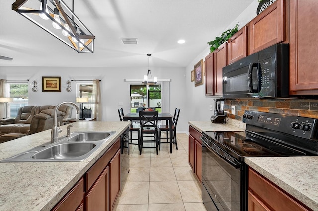 10409 Candleberry Woods Ln, Gibsonton, FL 33534 - kitchen with black appliances, open floor plan, light countertops, hanging light fixtures, and recessed lighting
